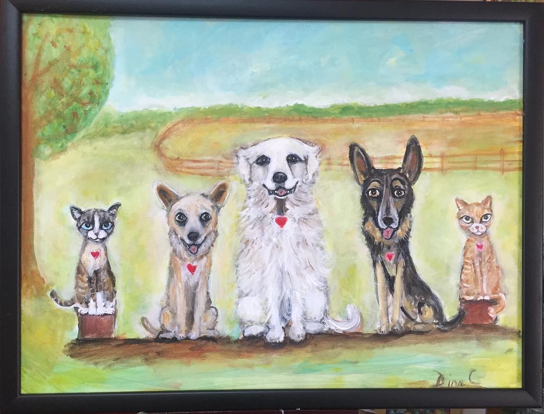 Pet family of three dogs and two cats with nature background