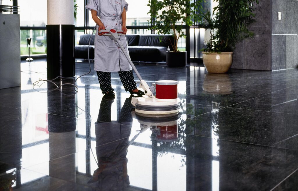 A woman is cleaning the floor.