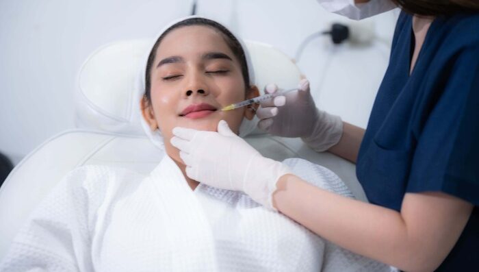 A skin Specialist giving treatment to his patient