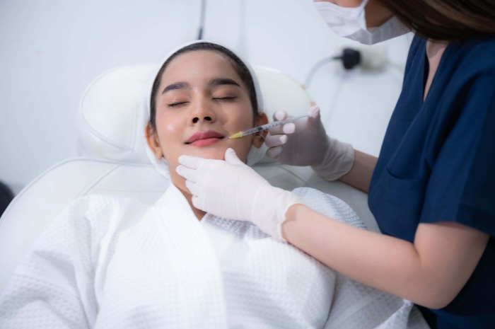 A skin Specialist giving treatment to his patient