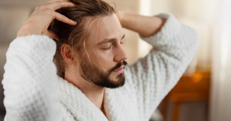 imageye man giving himself scalp massage scaled 1