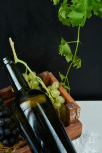 bunch grapes wine bottle white table close up high quality photo 1