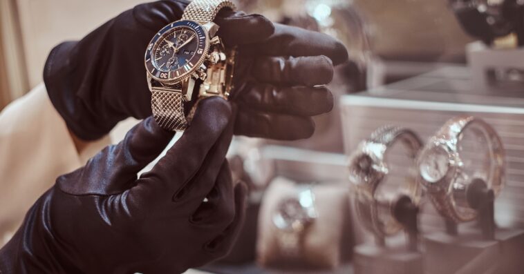 close up seller s hands gloves shows exclusive men s watch from new collection luxury jewelry store 1
