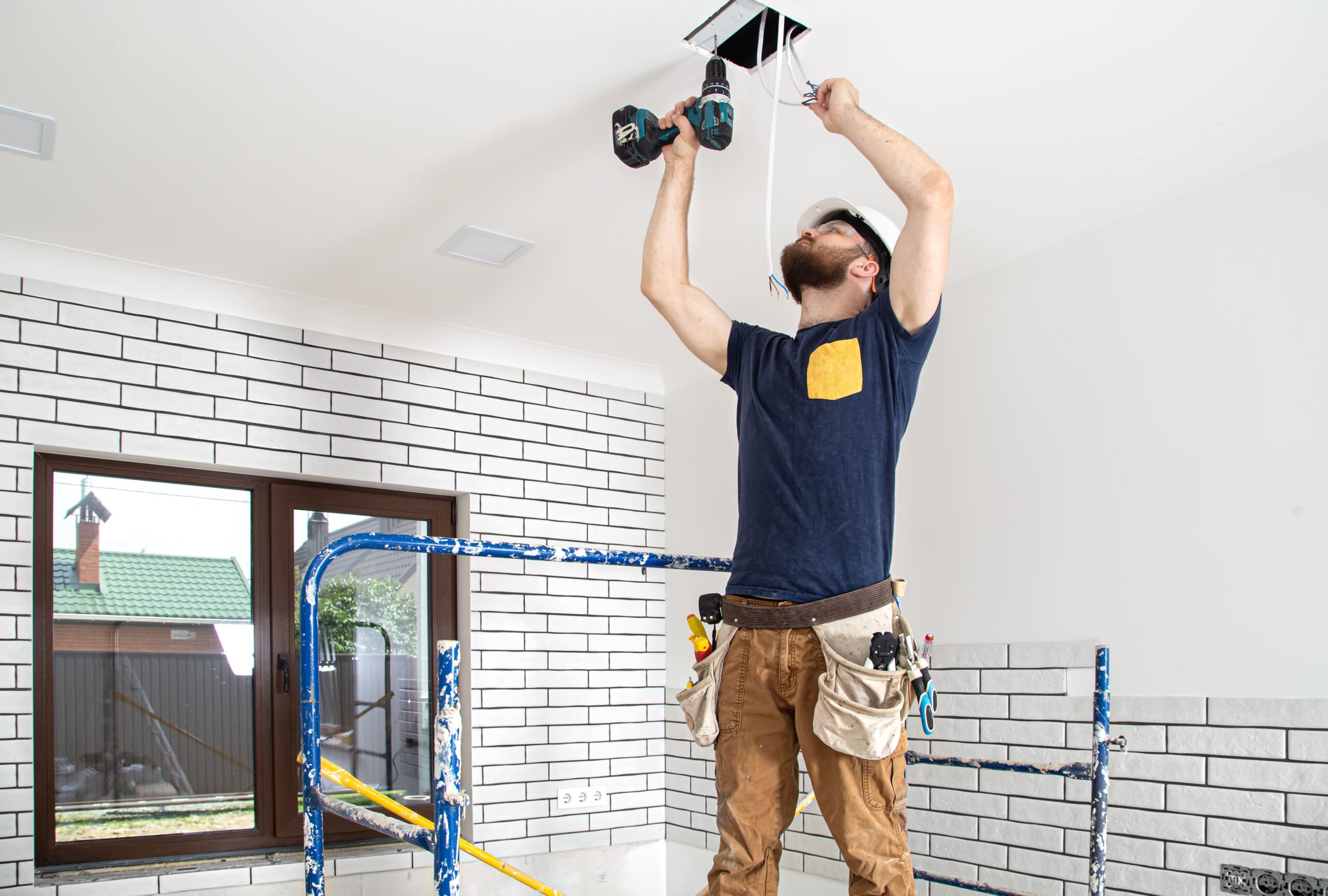Professional Fan Installation Brisbane – Residential & Commercial Experts 1 electrician builder work installation lamps height professional overalls with drill repair site 1 scaled