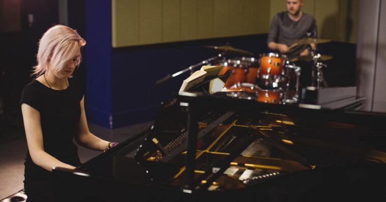 female male students playing piano drum set 2