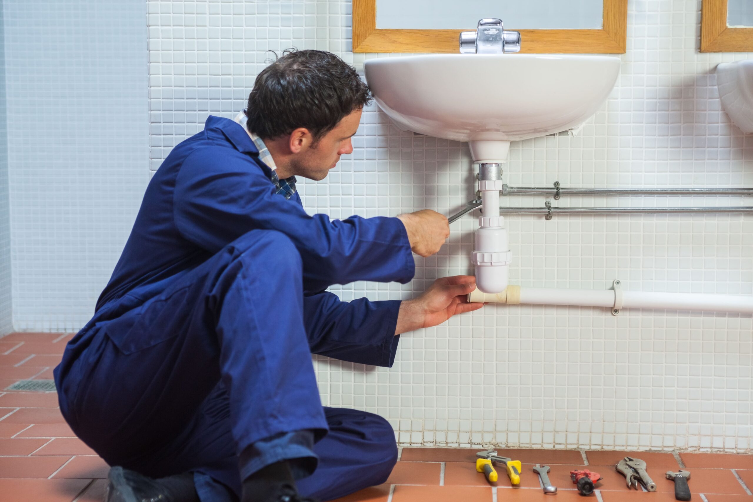 Professional Plumbing Repair Services – Reliable & Efficient 1 handsome plumber repairing sink 1 scaled