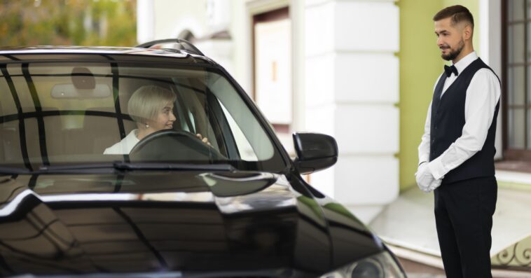 parking valet welcoming woman with car 1
