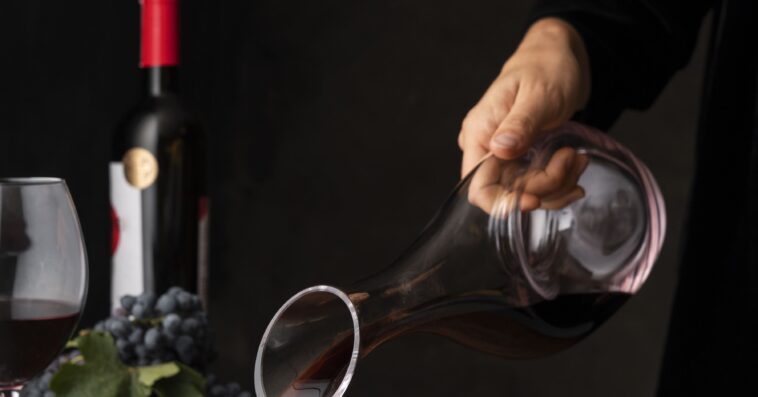 side view hand pouring wine glass 1