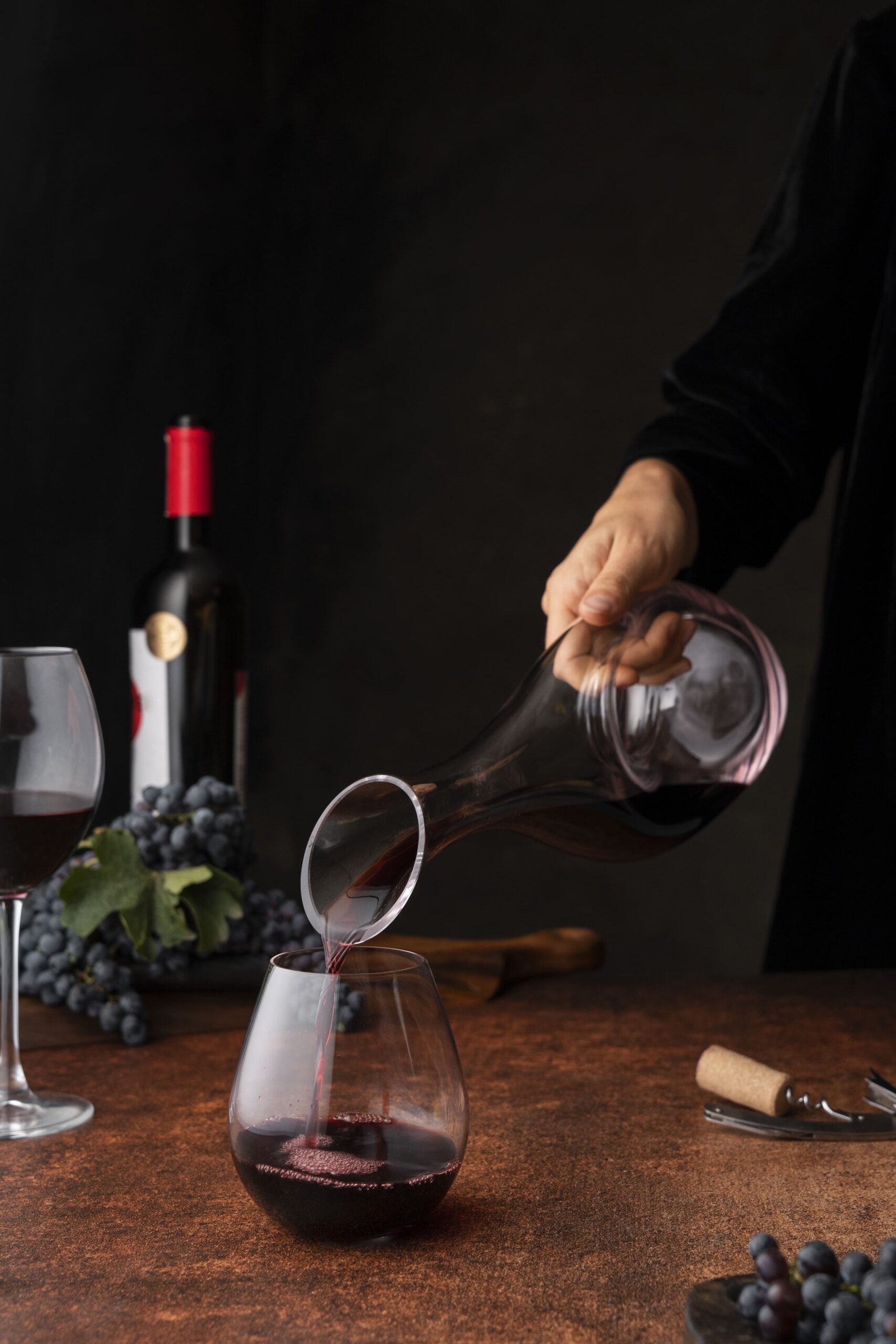 side view hand pouring wine glass 1 scaled