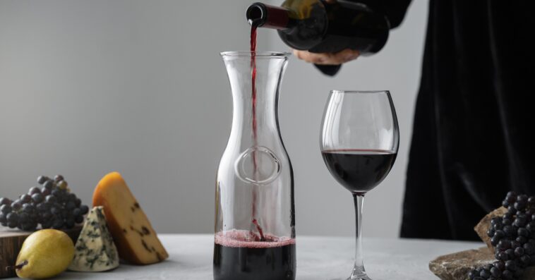 side view man pouring wine carafe 2 1
