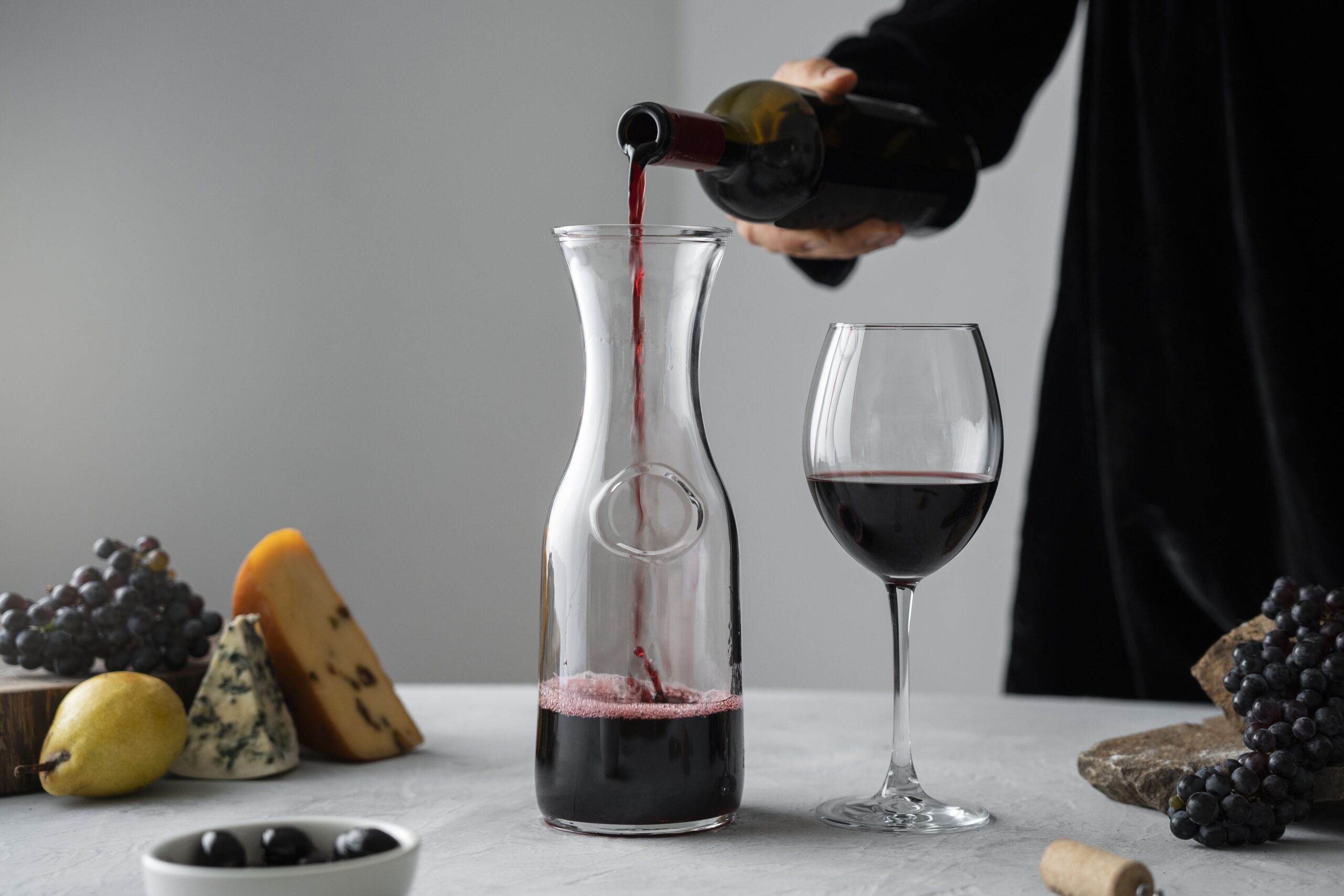 Looking for the best tasting Pinot Noir wine 1 side view man pouring wine carafe 2 1 scaled