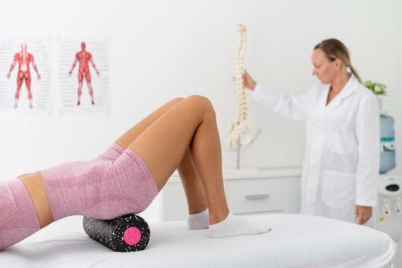 young woman with back problems doing physiotherapy treatment