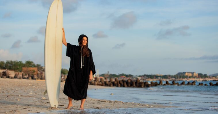 beautiful girl stands beach with surfboard 1 1