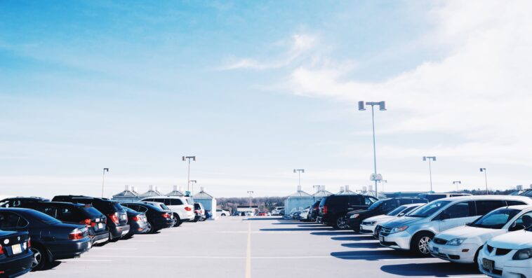 cars parked parking lot against sky 1