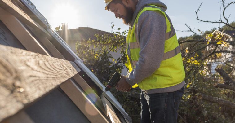 man working roof with drill 1