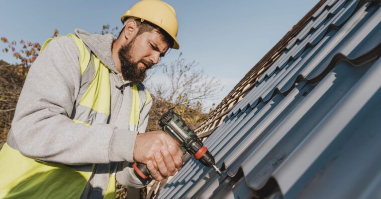 sideways man working roof with drill 1 1