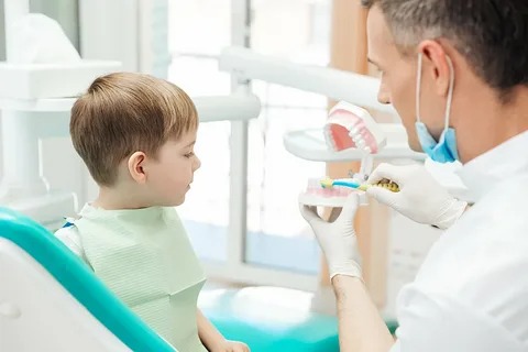 Pediatric dentist in Montclair gently treating a child with special needs in a sensory-friendly dental room