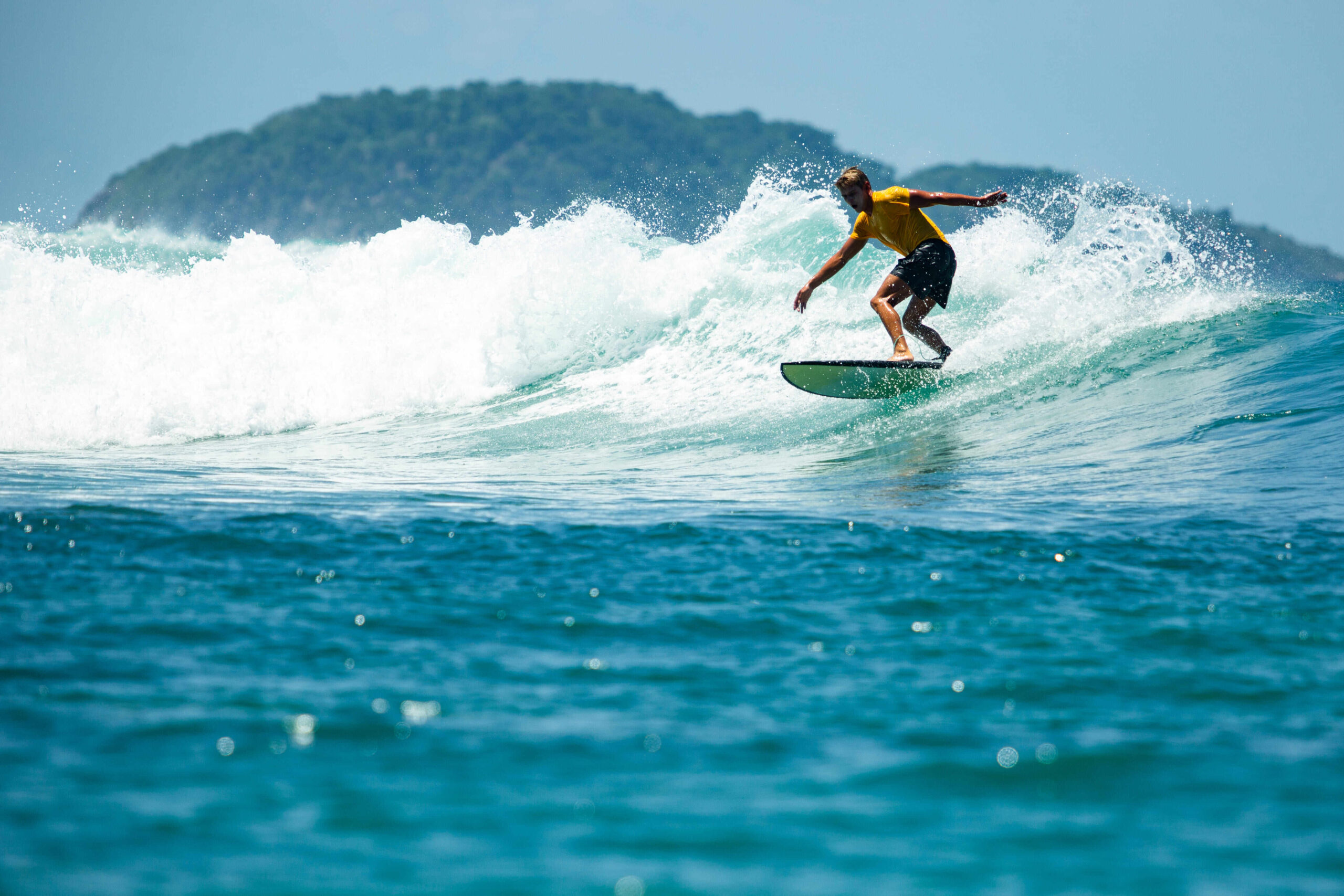 Surf, Unwind, Repeat at Surfcamp Lombok 1 surfer blue wave 1 1 scaled