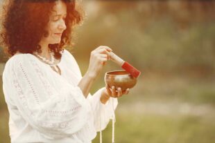 woman holding chanting bowl nature setting 1 1