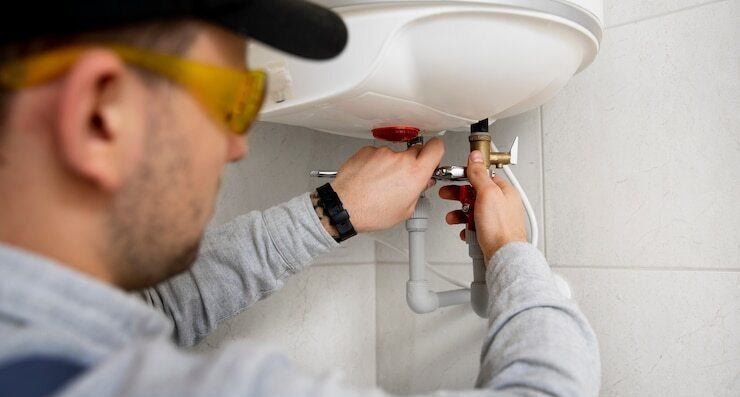 worker repairing water heater 23 2149334231 ezgif.com webp to jpg converter