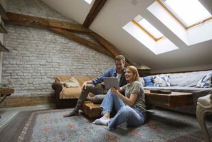 young couple using tablet sitting floor home 1 1