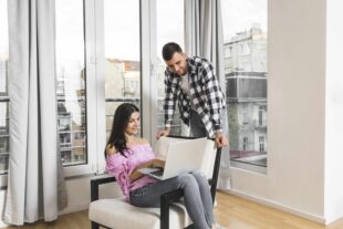 young man looking his girlfriend using laptop home 2 1 1 1