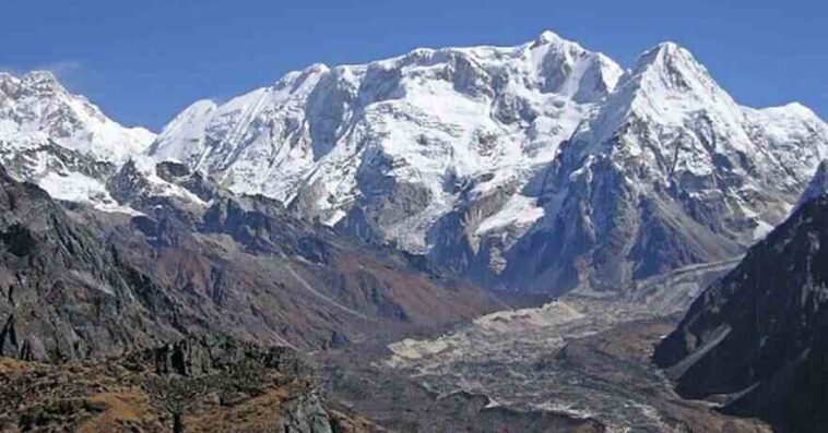 Mount Kanchenjunga peak in Nepal with snow-covered slopes under clear blue sky