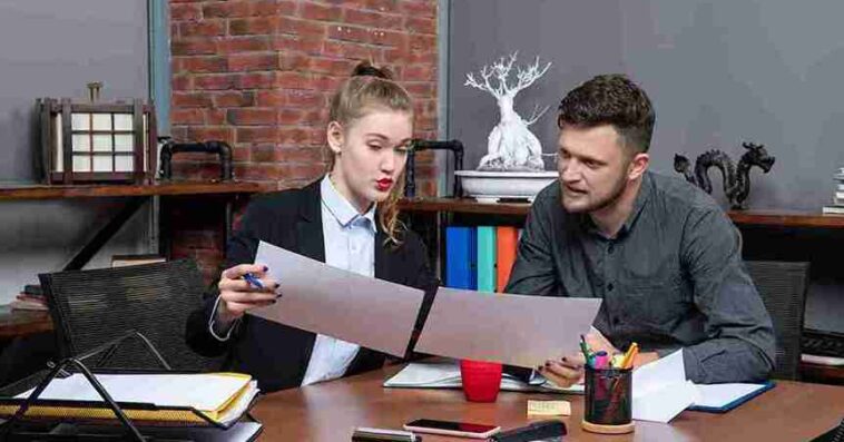 top view young busy motivated clerical workers discussing one issue documents office 11zon