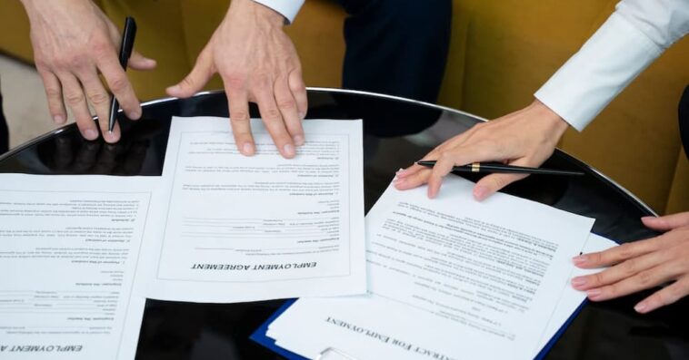 high angle hands signing documents 1 1