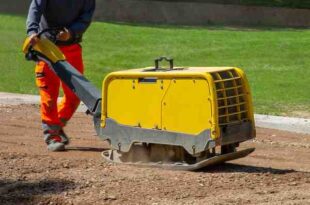 construction worker working road with vibratory plate 1