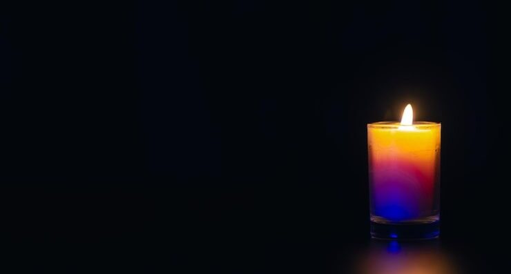 burning candle black background